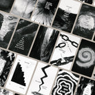 A spread of Arcana Cordis cards with black-and-white imagery and poetic phrases